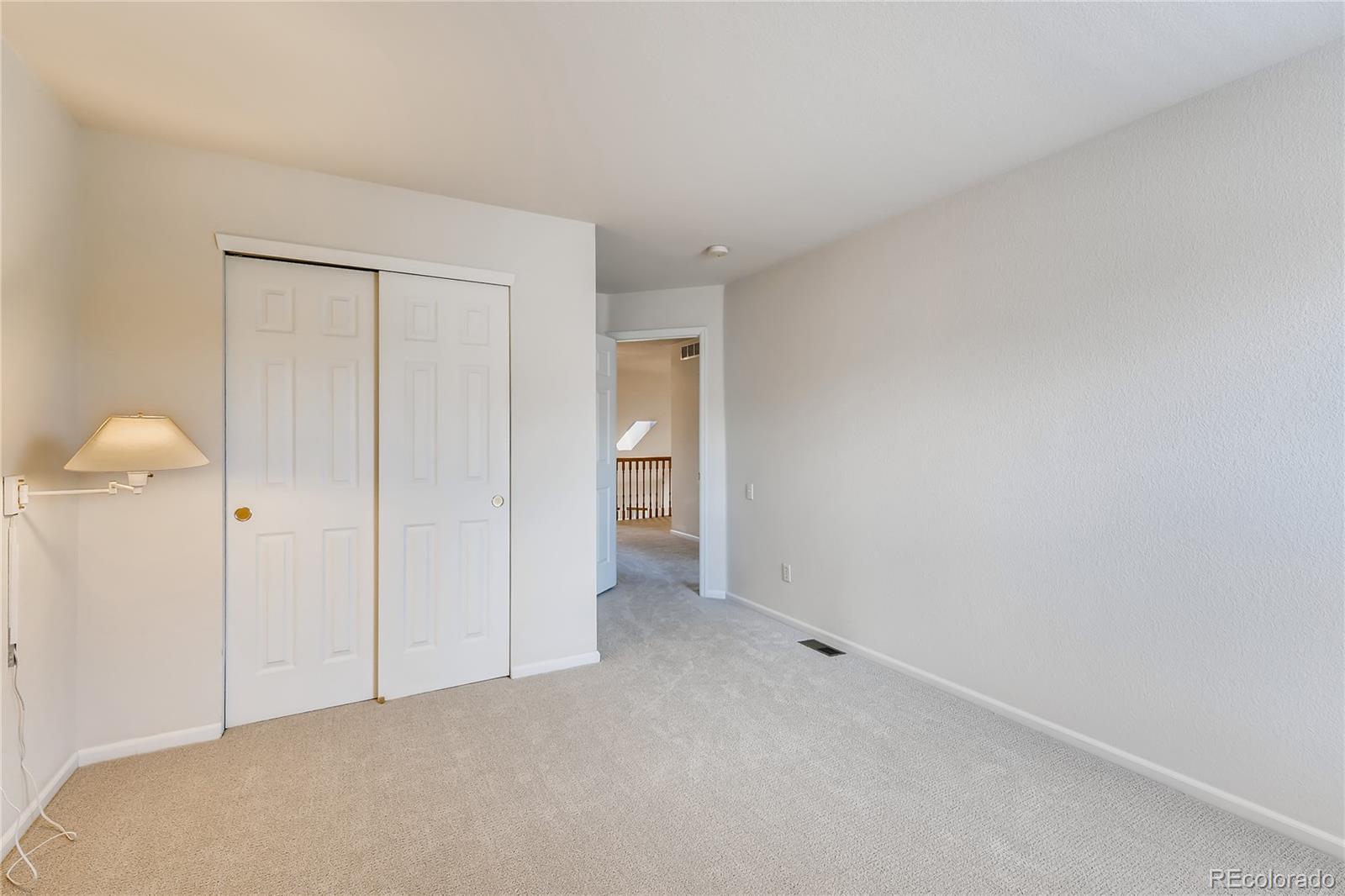 6137 Trailhead Road Highlands Ranch, CO 80130 - Photo 15 of 27 a view of an empty room and a lamp