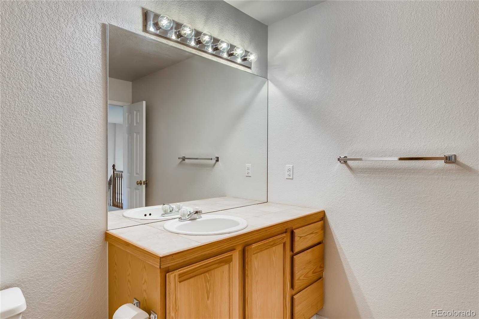 6137 Trailhead Road Highlands Ranch, CO 80130 - Photo 16 of 27 a bathroom with a sink and a mirror