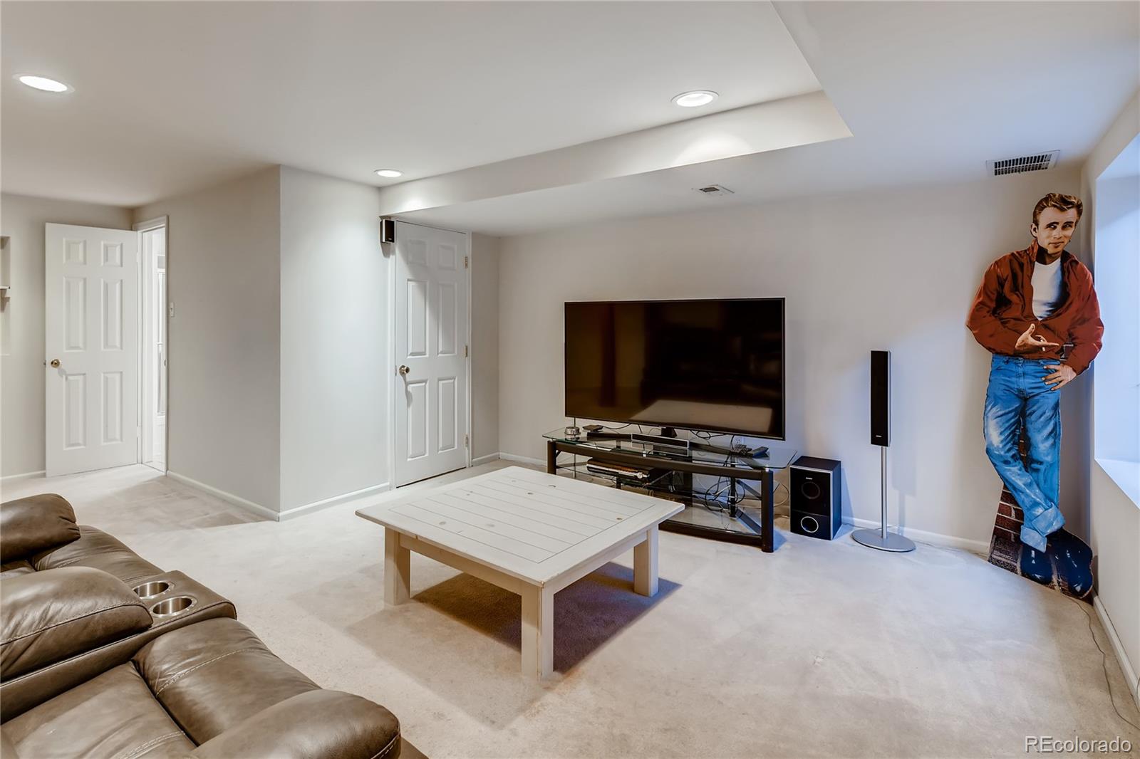 6137 Trailhead Road Highlands Ranch, CO 80130 - Photo 20 of 27 a living room with furniture and a flat screen tv