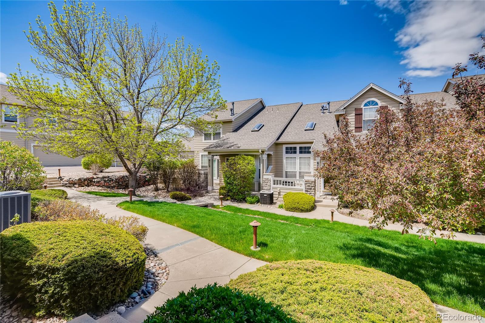 6137 Trailhead Road Highlands Ranch, CO 80130 - Photo 27 of 27 a front view of a house with garden and trees