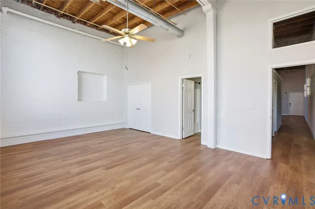 a view of an empty room with wooden floor