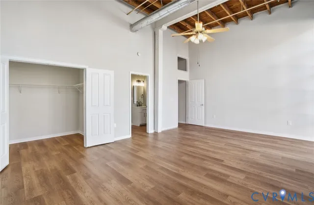 a view of empty room with wooden floor