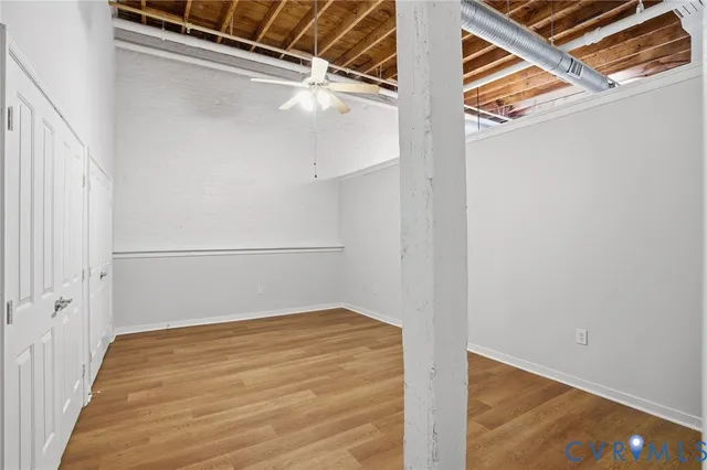 a view of a room with wooden floor