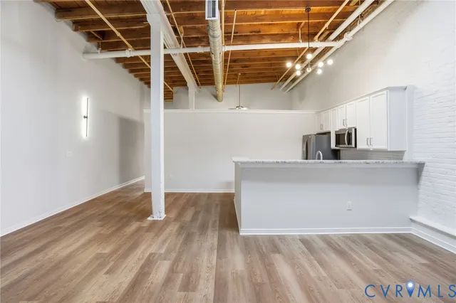 a view of a room with wooden floor and staircase