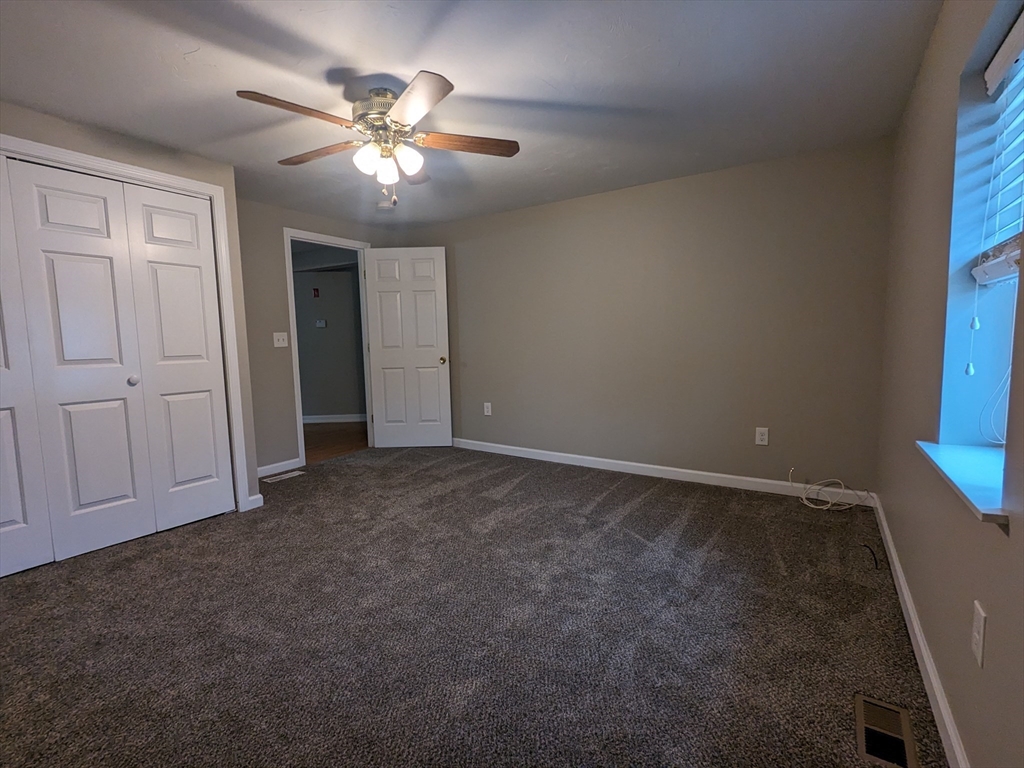 16 Hartness Road, Unit A Sutton, MA 01590 - Photo 13 of 18 a view of an empty room with a chandelier fan