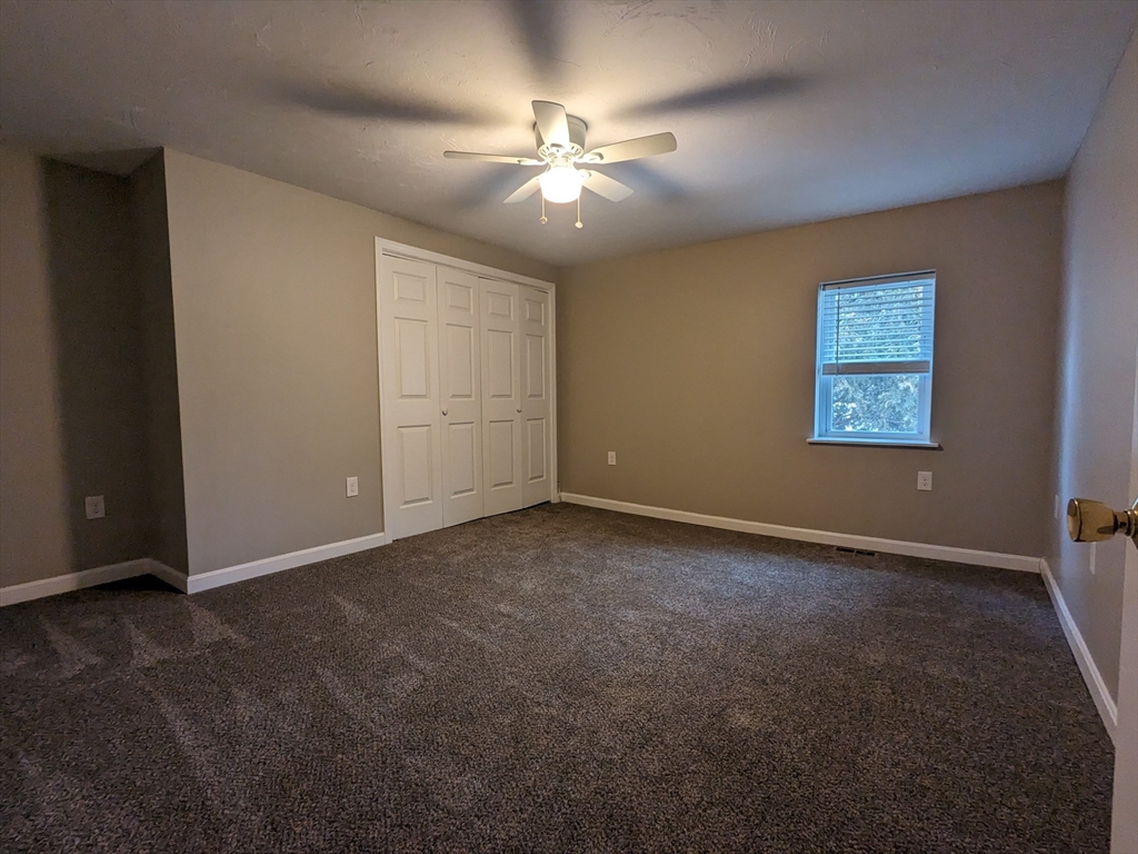16 Hartness Road, Unit A Sutton, MA 01590 - Photo 17 of 18 an empty room with closet and fan