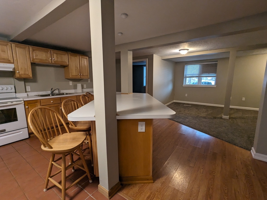 16 Hartness Road, Unit A Sutton, MA 01590 - Photo 3 of 18 a view of kitchen with furniture and wooden floor