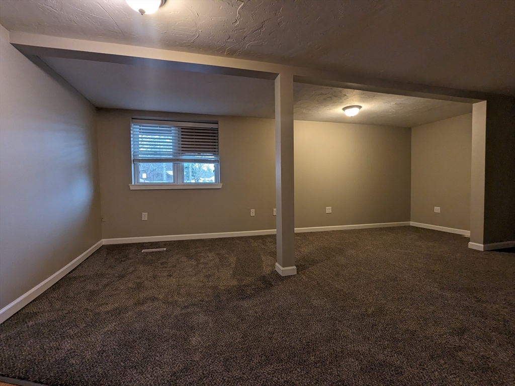 16 Hartness Road, Unit A Sutton, MA 01590 - Photo 8 of 18 an empty room with windows
