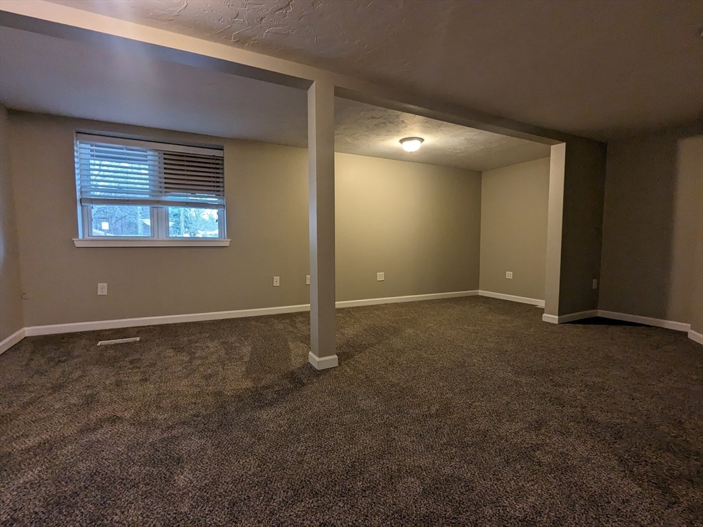 16 Hartness Road, Unit A Sutton, MA 01590 - Photo 9 of 18 a view of an empty room with a window