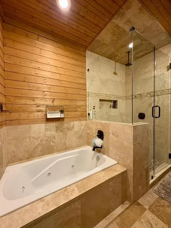 a bathroom with a tub and shower