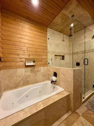 a bathroom with a tub and shower