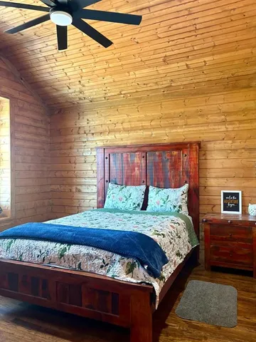 a bedroom with a bed and a night stand