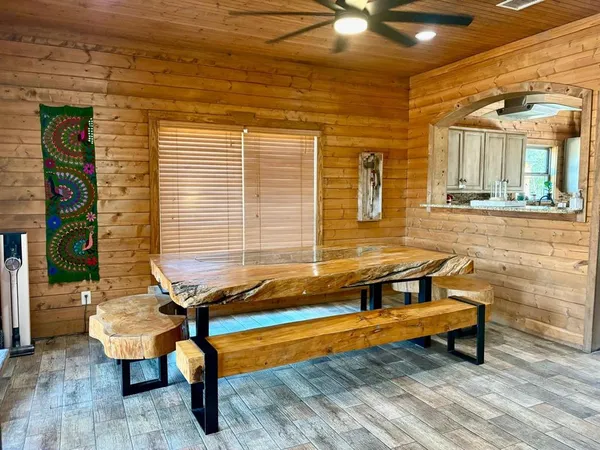 a backyard of a house with barbeque oven table and chairs