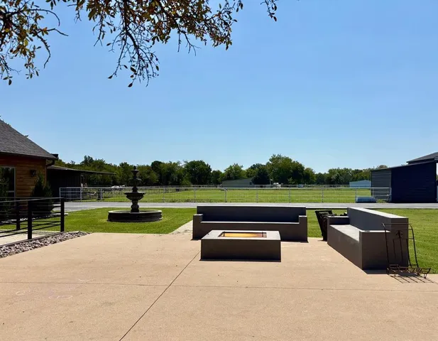 a view of swimming pool with outdoor seating and a garden