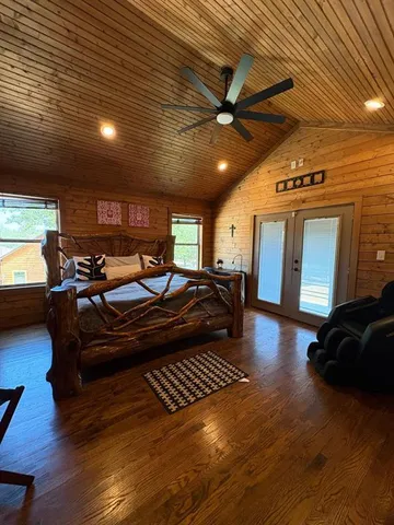 a living room with furniture a flat screen tv and kitchen view