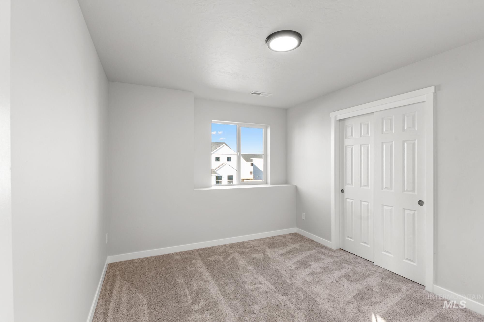 13713 Judson Street Caldwell, ID 83607 - Photo 13 of 24 Unfurnished bedroom with light carpet and a closet