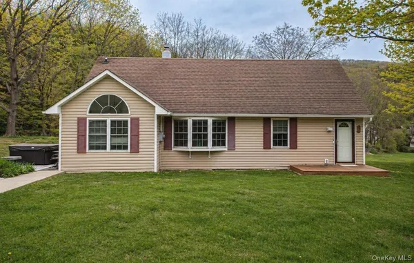 a front view of a house with a garden and yard