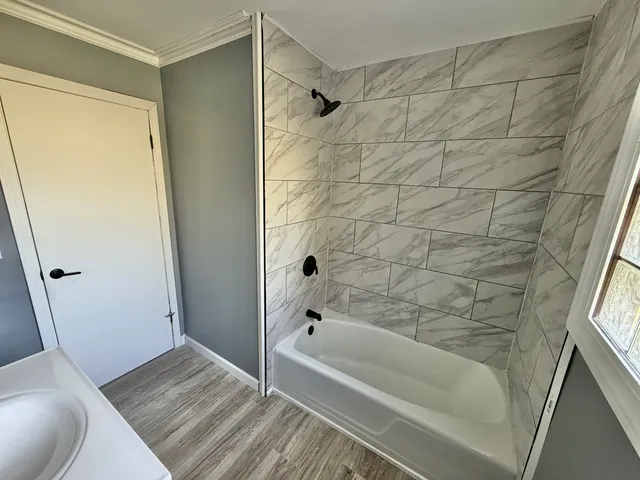 a bathroom with a bathtub and a shower