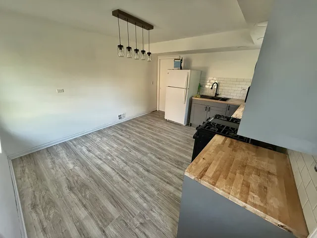 a view of a room with wooden floor and staircase