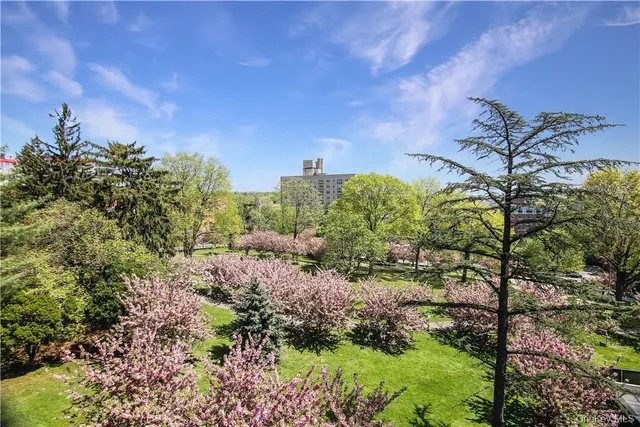 a picture of a bench in front of a white house