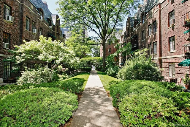 a view of a garden with a house
