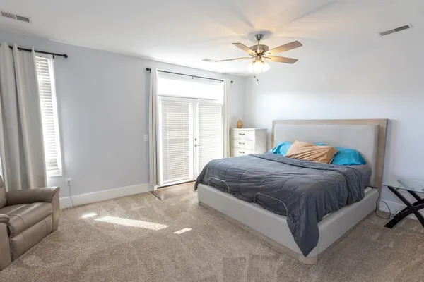 a spacious bedroom with a bed and window