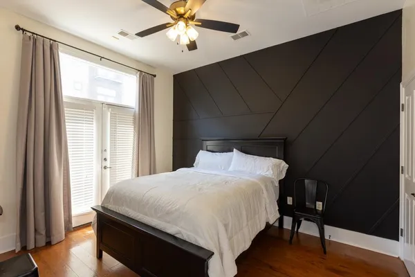 a bedroom with a bed and a chandelier