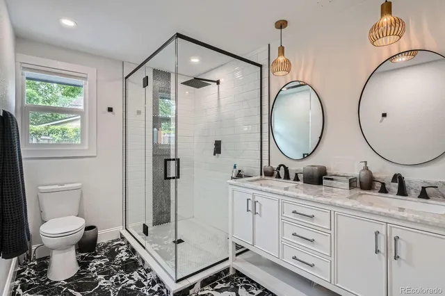 a bathroom with a toilet a sink and a mirror