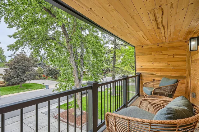 a view of balcony with wooden floor and fence