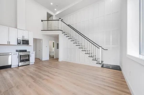 a view of staircase and kitchen with sink