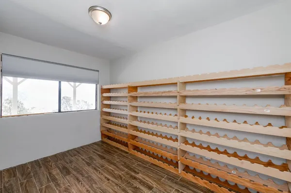 a view of a room with wooden floor and door