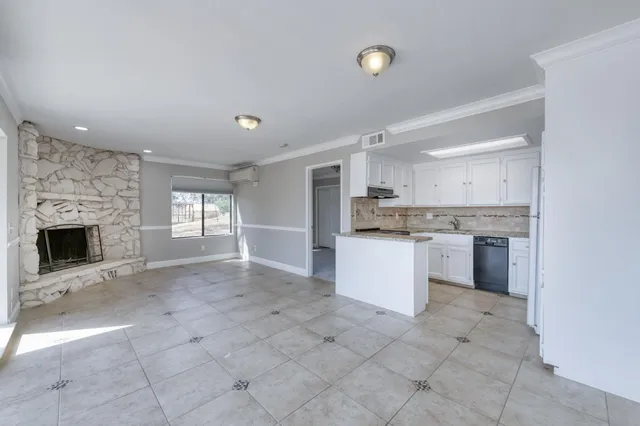 a view of a kitchen with a sink cabinets and a fireplace