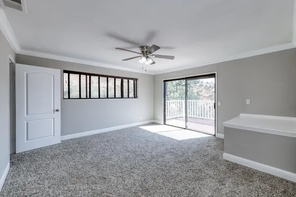 a view of an empty room with a fireplace and a large window