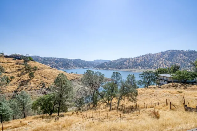 a view of a dry yard with mountains in the background