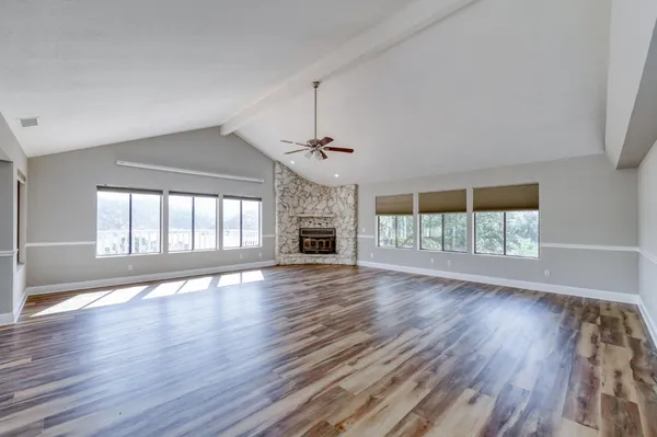 wooden floor in an empty room with a fireplace