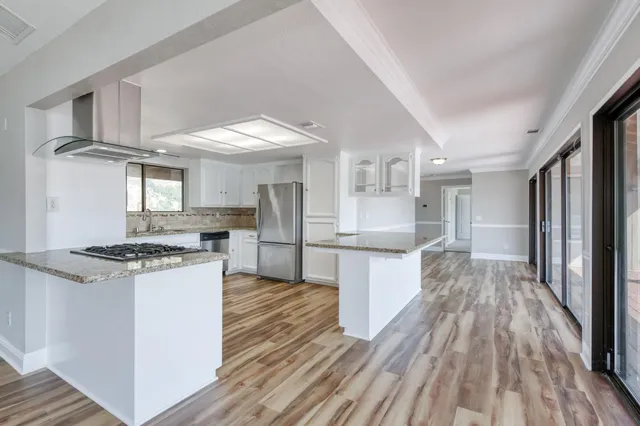 a kitchen with stainless steel appliances granite countertop a stove and a refrigerator