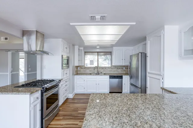 a kitchen with refrigerator and stove