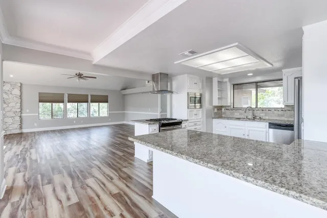 a view of a kitchen with a sink and a living room area
