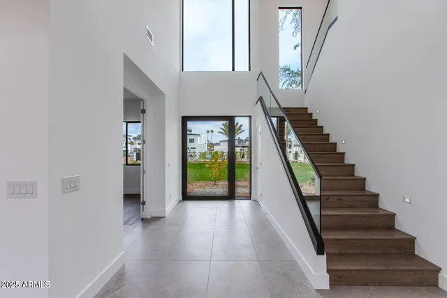 a view of entryway and hall with wooden floor
