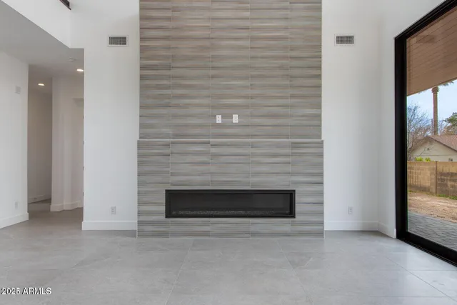 a view of empty room with a fireplace
