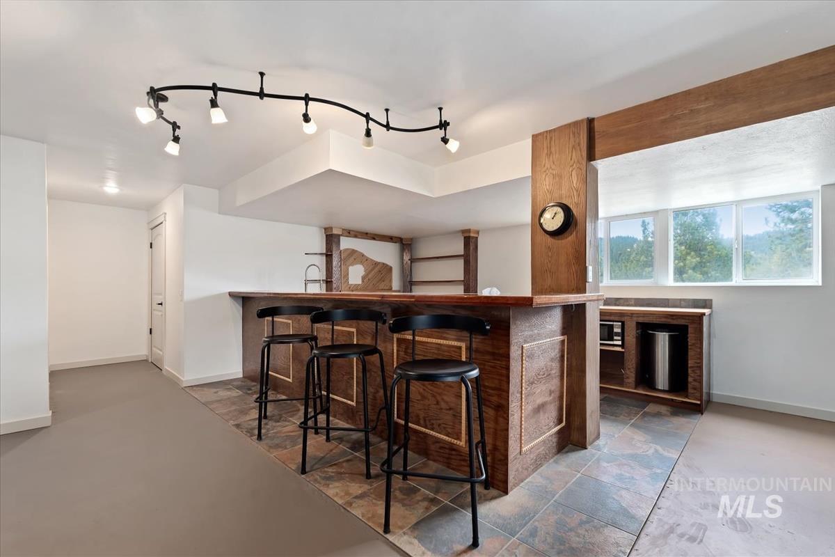 6 East Beck Road Garden Valley, ID 83622 - Photo 29 of 44 Indoor bar featuring baseboards and rail lighting