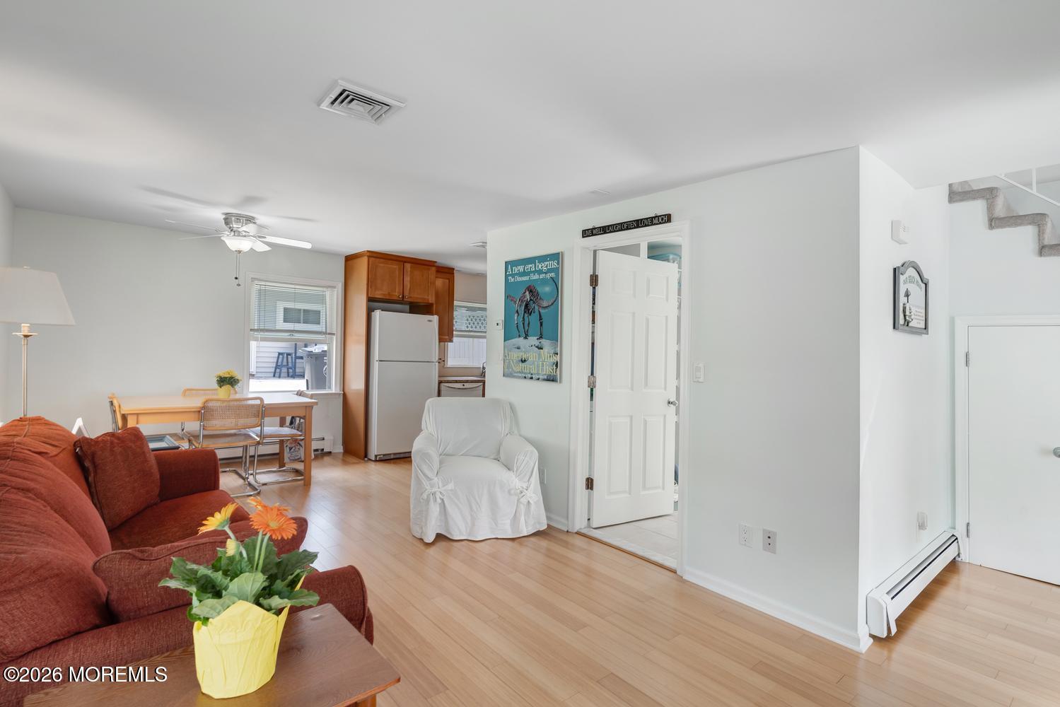 19 Shore Way Lavallette, NJ 08735 - Photo 6 of 38 a living room with furniture and a chandelier