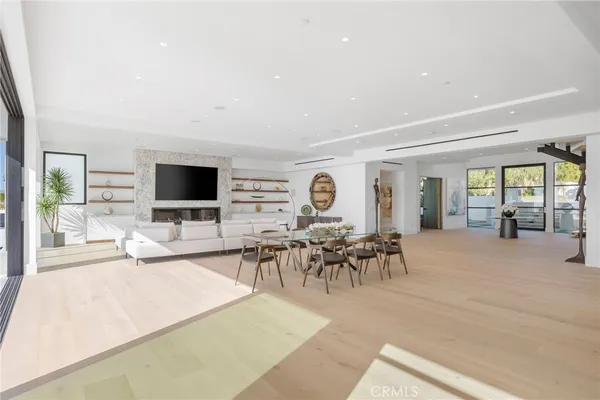 a living room with patio furniture and a flat screen tv
