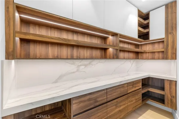 a spacious bedroom with a bed and a cabinets