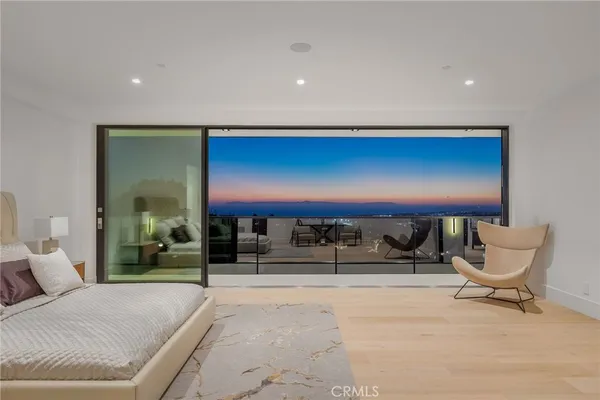 a bedroom with furniture and large windows