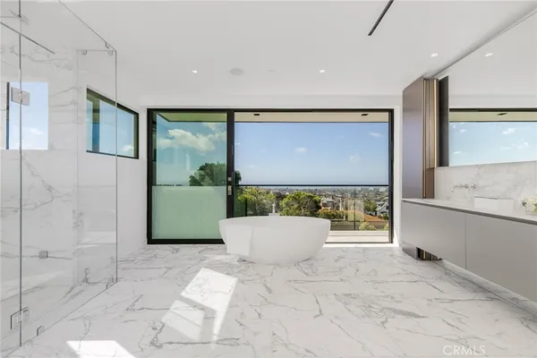 a living room with furniture a flat screen tv and kitchen view