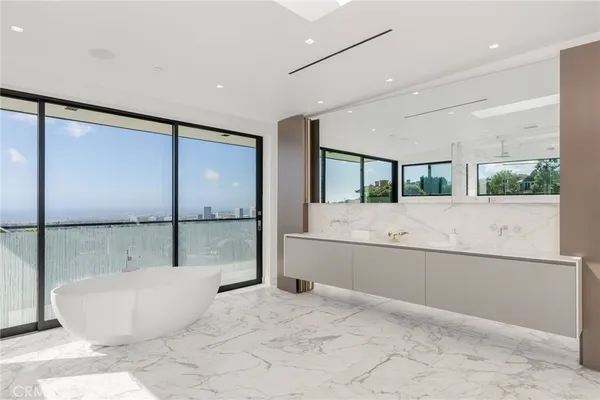 a large bed sitting in a room next to a balcony