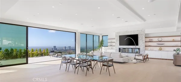 a dining room with furniture a floor to ceiling window and view