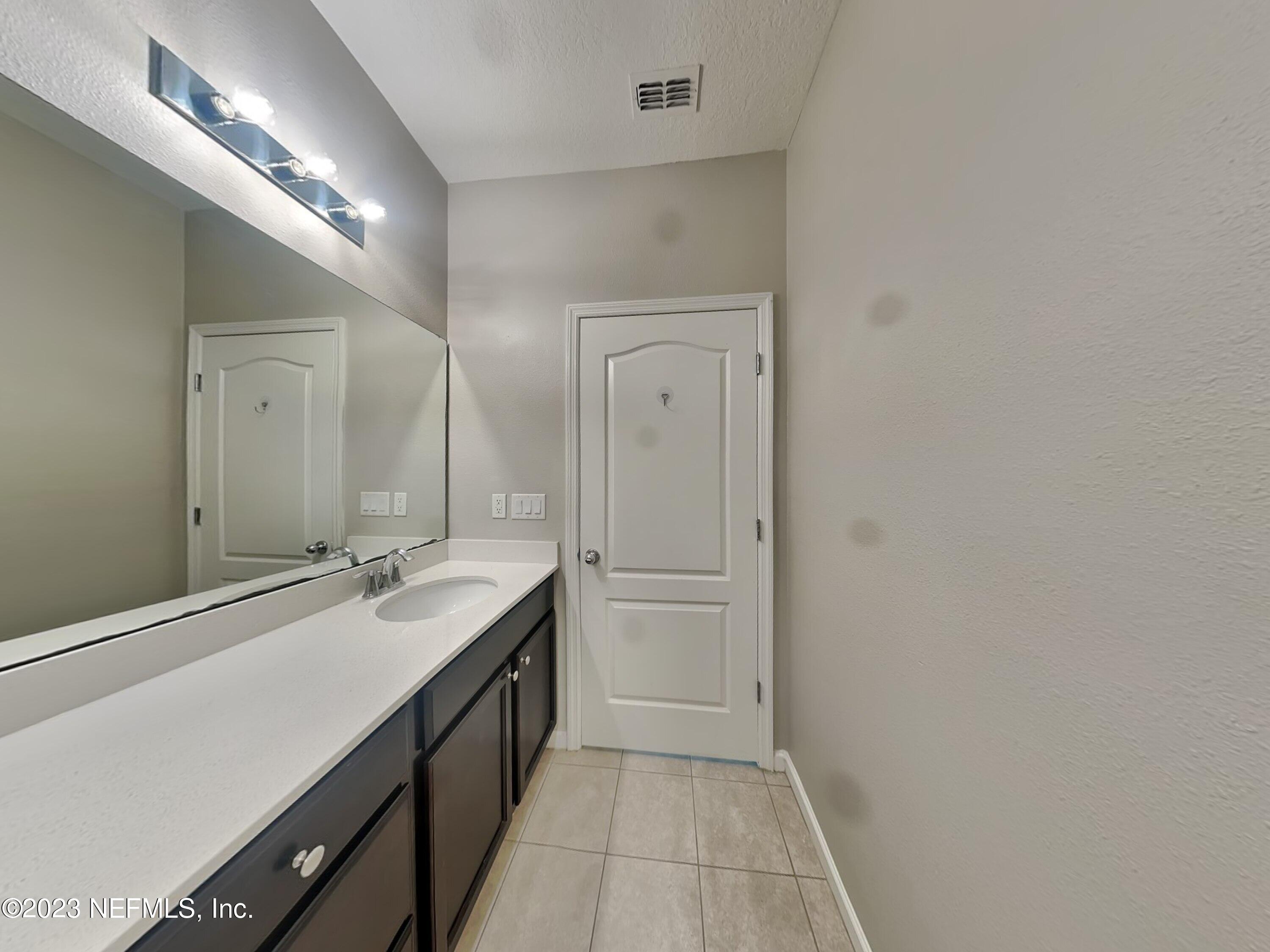164 Bloomfield Way St. Augustine, FL 32092 - Photo 14 of 21 a spacious bathroom with a double vanity sink a and a mirror