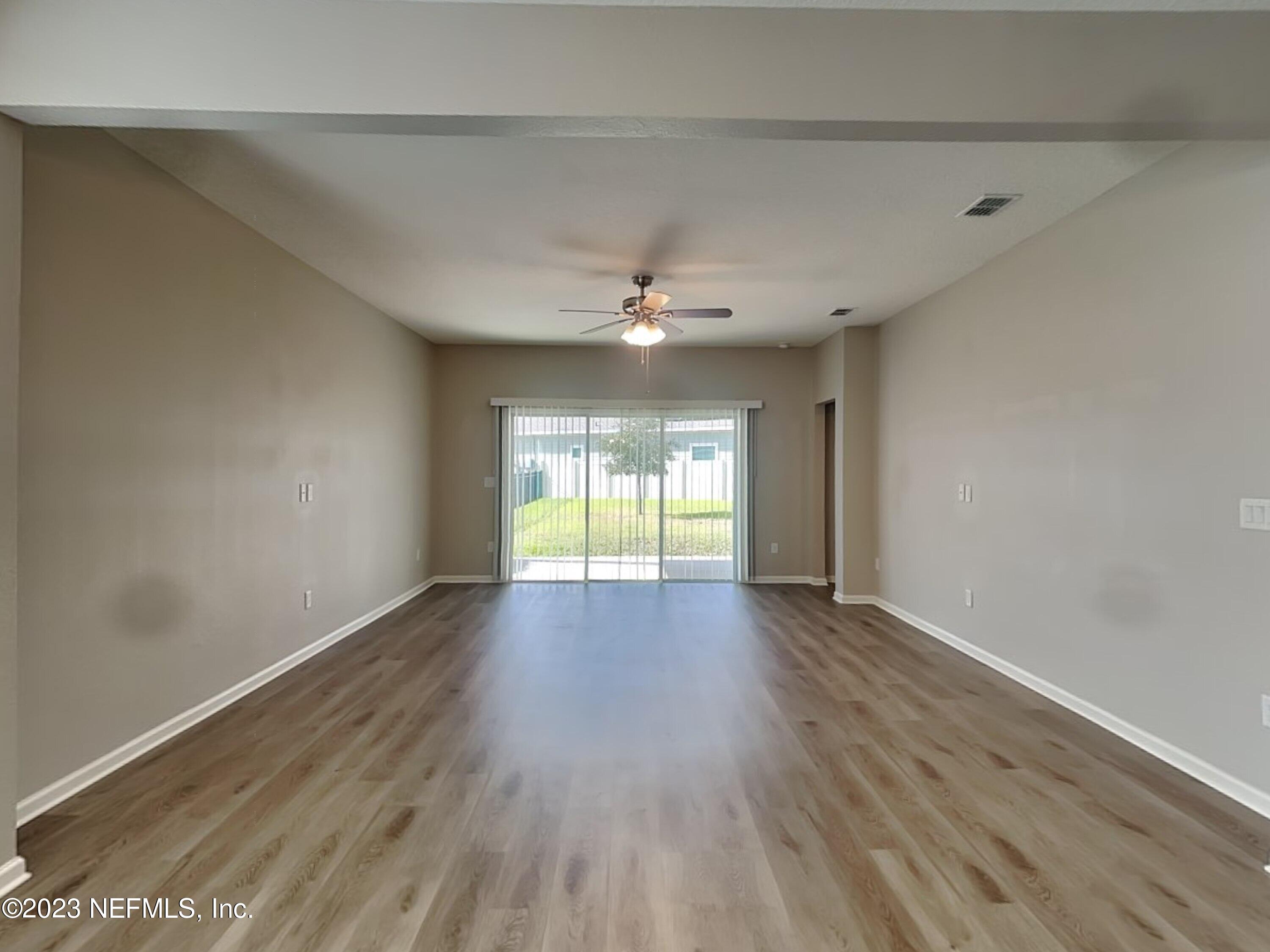 164 Bloomfield Way St. Augustine, FL 32092 - Photo 2 of 21 wooden floor in an empty room with a window